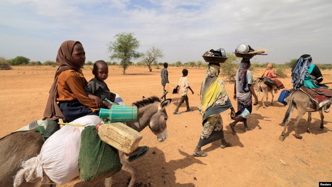 The United Nations refugee agency said Friday that 200,000 people have fled the violence in Sudan, including these families walking through the desert after crossing the border between Sudan and Chad to seek refuge in Goungour, Chad, May 12, 2023.