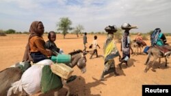 The United Nations refugee agency said Friday that 200,000 people have fled the violence in Sudan, including these families walking through the desert after crossing the border between Sudan and Chad to seek refuge in Goungour, Chad, May 12, 2023.