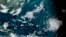 This satellite image provided by the U.S. National Oceanographic and Atmospheric Administration shows Hurricane Lee, right, in the Atlantic Ocean, Sept. 8, 2023. (NOAA via AP)