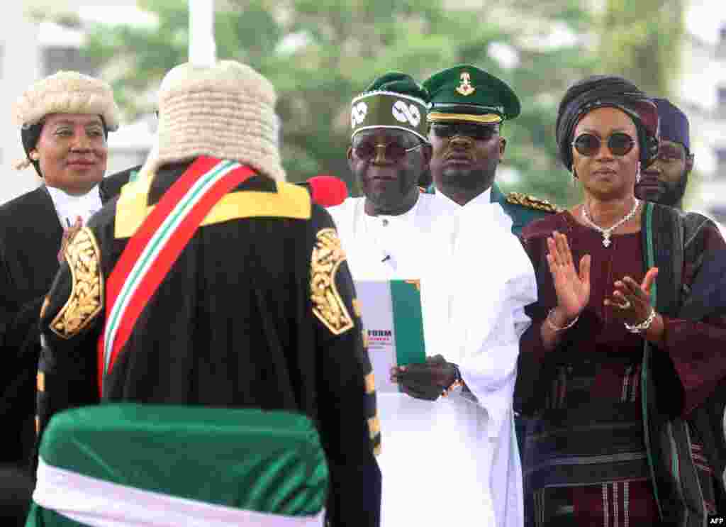 Nigeria's President Bola Tinubu, center, takes oath of office during during his inauguration ceremony at the Eagle Square in Abuja, Nigeria, May 29, 2023. 