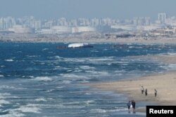 Aid delivered by the Open Arms vessel arrives off the coast of Gaza, amid the ongoing conflict between Israel and the Palestinian Islamist group Hamas, as seen from central Gaza Strip, March 15, 2024.