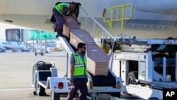 Airport workers unload bodies of Afghans at Kabul International Airport in Afghanistan, May 24, 2023. Eighteen Afghan migrants died while being smuggled into Bulgaria. (Afghanistan Foreign Ministry via AP)