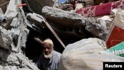 Hammou Baha Ali, 80, searches for his belongings in the ruins of a house, in the aftermath of a deadly earthquake in Talat N'Yaaqoub, Morocco September 15, 2023. 