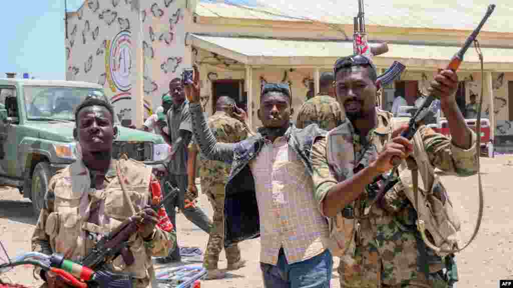 This picture taken on April 16, 2023, shows Sudanese army soldiers, loyal to army chief Abdel Fattah al-Burhan, posing for a picture at the Rapid Support Forces (RSF) base in the Red Sea city of Port Sudan. (AFP)