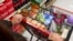 FILE - Jaqueline Benitez shops for groceries at a supermarket in Bellflower, Calif., Feb. 13, 2023. 