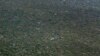 FILE - A Kenyan army helicopter flies over forest near Kismayo, Somalia, on Oct. 2, 2012, where allied African troops were fighting al-Shabab Islamist rebels. Al-Shabab limits tree cutting in areas of Somalia it controls, in part to hide it from aerial attack.