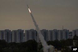 FILE - Israel's Iron Dome anti-missile system fires to intercept a rocket launched from the Gaza Strip towards Israel, near Ashkelon, May 11, 2023.