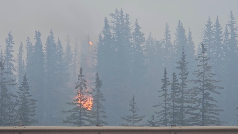 Blaze in Canadian tourist town still out of control, but rain helping firefighters 