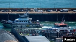 People believed to be migrants, disembark from a British Border Force vessel as they arrive at the Port of Dover in Dover, Britain, April 29, 2024.