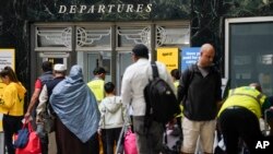 Passengers arrive at LaGuardia Airport as the Memorial Day holiday weekend marks the unofficial start of the summer travel season, Thursday, May 25, 2023, in New York.  (AP Photo/Baby Matthews)