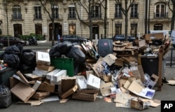 Uncollected garbage is piled up on a street in Paris, March 20, 2023, as strikes continue with uncollected garbage piling higher by the day. (AP Photo/Aurelien Morissard, File)
