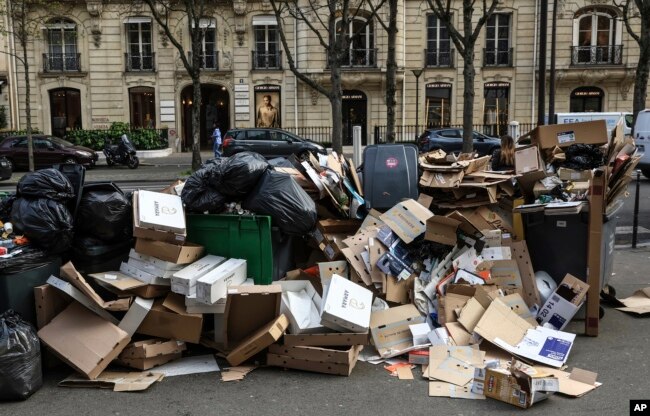 Uncollected garbage is piled up on a street in Paris, March 20, 2023, as strikes continue with uncollected garbage piling higher by the day. (AP Photo/Aurelien Morissard, File)