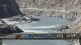 FILE - View of a bridge with China and Pakitan's flag over the River Indus, at the site of Dasu Dam or Dasu Hydropower Project, in Kohistan district Kyber Pakhtunkhwa province, near Dasu, Pakistan, Oct. 6, 2023. 