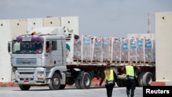 A truck carrying humanitarian aid bound for the Gaza Strip drives at the inspection area at the Kerem Shalom crossing, amid the ongoing conflict between Israel and the Palestinian Islamist group Hamas, in southern Israel, March 14, 2024.