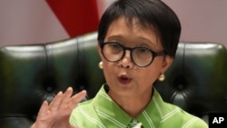 Indonesian Foreign Minister Retno Marsudi speaks during a news conference in Jakarta, Indonesia, May 5, 2023, about efforts to rescue dozens of its nationals who got trafficked to Myanmar to work as cyber scammers. Some of the were freed Sunday.