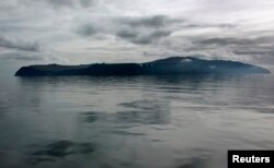 FILE - The island of Big Diomede sits in the morning mist on the Russian side of the Bering Strait, as seen from the Russian research vessel Professor Khromov, Aug. 28, 2009.