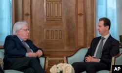 In this photo released on the official Facebook page of the Syrian Presidency, Syrian President Bashar al-Assad, right, meets with Martin Griffiths, United Nations Under-Secretary-General for Humanitarian Affairs, in Damascus, Syria, Feb. 13, 2023.