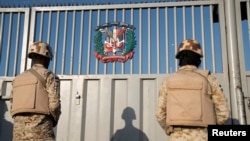 Dominican Republic soldiers keep watch at a gate on the border with Haiti, in Dajabon, Dominican Republic, March 18, 2024.