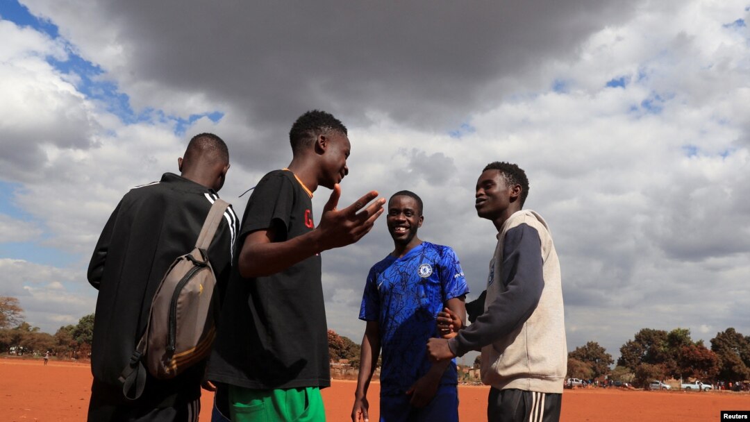 FILE - Tinotenda Mandizha, 25, a footballer and first-time voter talks with his friends at Chimbumu playground in Kuwadzana, Harare, Zimbabwe, August 5, 2023. 