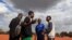 FILE - Tinotenda Mandizha, 25, a footballer and first-time voter talks with his friends at Chimbumu playground in Kuwadzana, Harare, Zimbabwe, August 5, 2023. 
