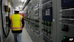Mike Nutt, site manager, walks the campus at Orsted's Eleven Mile Solar Center lithium-ion battery storage energy facility, Feb. 29, 2024, in Coolidge, Ariz.