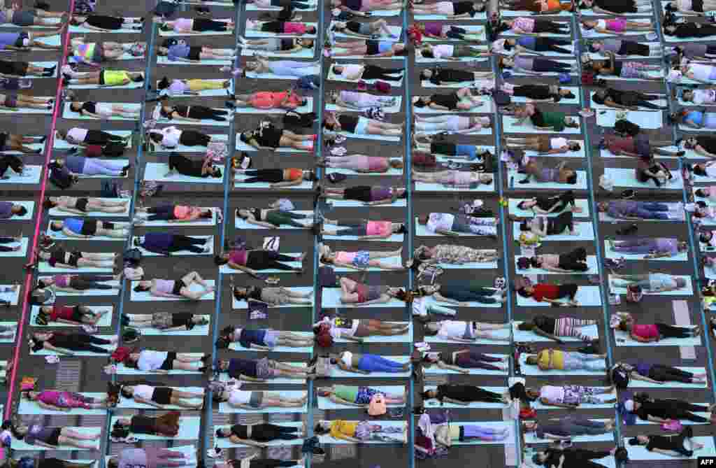 People take part in the 22nd annual &quot;Solstice in Times Square: Mind Over Madness Yoga&quot; in Times Square, New York City.