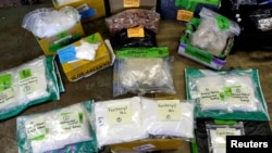 FILE - Plastic bags of fentanyl are displayed on a table at the U.S. Customs and Border Protection area at the International Mail Facility at O'Hare International Airport in Chicago, Nov. 29, 2017.