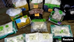 FILE - Plastic bags of fentanyl are displayed on a table at the U.S. Customs and Border Protection area at the International Mail Facility at O'Hare International Airport in Chicago, Nov. 29, 2017.