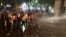 Law enforcement officers use a water cannon to disperse the crowd near the parliament building during a rally to protest against a bill on "foreign agents" in Tbilisi, Georgia, April 30, 2024.