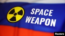 (FILE) A Russian flag, a nuclear sign and the words "space weapon" are seen in this illustration. 