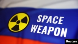 A Russian flag, the nuclear symbol and the words "space weapon" are seen in this illustration photo taken March 13, 2024. Russia's defense minister has denied that Moscow is developing a space-based anti-satellite nuclear weapon.