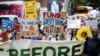 Tens of thousands march to kick off climate summit, demanding end to warming-causing fossil fuels 