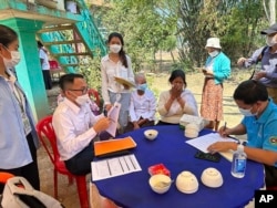 In this photo released by the Cambodia Ministry of Health, Cambodia animal health experts educate the villagers to take care of their health, in Prey Veng eastern province Cambodia, Thursday, Feb. 23, 2023. (Cambodia Ministry of Health via AP)