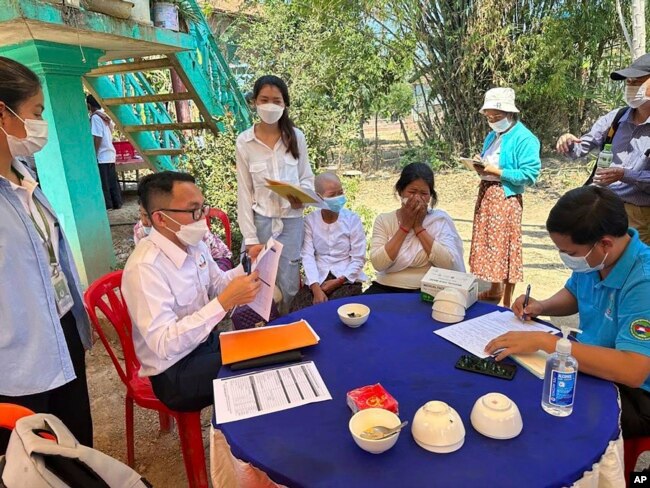 In this photo released by the Cambodia Ministry of Health, Cambodia animal health experts educate the villagers to take care of their health, in Prey Veng eastern province Cambodia, Thursday, Feb. 23, 2023. (Cambodia Ministry of Health via AP)