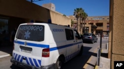 FILE - An ambulance drives through the entrance of a hospital on the island of Rhodes, where the body of British television anchor Michael Mosley was taken following his death while vacationing on the nearby island of Symi, June 10, 2024.