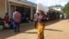 FILE - A woman carries maize meal from a United Nations World Food Program distribution center in Neno district, southern Malawi, March 24, 2024. Drought left millions facing hunger in southern Africa; Malawi declared a state of disaster this year.