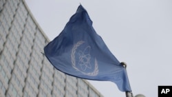 Bendera Badan Energi Atom Internasional (IAEA) berkibar di depan kantor pusatnya selama pertemuan Dewan Gubernur IAEA di Wina, Austria, Senin, 6 Februari 2023. (AP Photo/Heinz-Peter Bader)