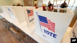 FILE - Empty poll kiosks await voters at the Mississippi Second Congressional District Primary election precinct June 7, 2022, in Jackson, Miss. 