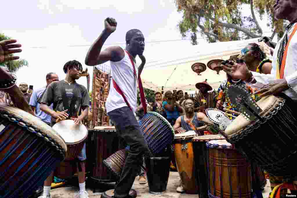 People attend a gathering to mark Juneteenth, which commemorates the end of slavery in Texas, over two years after the 1863 Emancipation Proclamation freed slaves elsewhere in the U.S., in Leimart Park, in Los Angeles, June 19, 2024. 