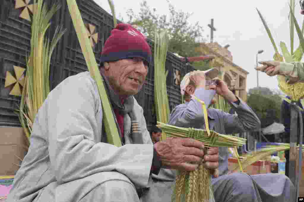 Vendors sell palm leaves during the Palm Sunday Mass at the Church and Monastery of the Virgin Mary, in Cairo, Egypt.