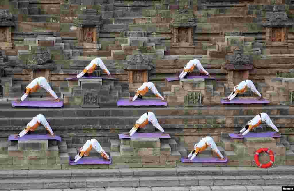 Participants perform a &quot;Surya Namaskar&quot; or sun salutation to welcome the new year at the Sun Temple in Modhera village near Ahmedabad, India.