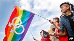 FILE - Supporters of LGBT and human rights wave rainbow flags during a rally supporting a proposal to allow same-sex marriage in Taipei, Taiwan, Dec. 10, 2016. In 2019, Taiwan became the first country in Asia to allow same-sex marriage.