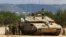 FILE - Israeli soldiers stand near to a tank near Israel's border with Lebanon in northern Israel, Oct. 16, 2023. Israel said on Nov. 3, 2024, that it launched a ground raid into Syria.