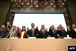 Move Forward Party leader Pita Limjaroenrat, center, and potential coalition partners are pictured in Bangkok, May 18, 2023, after his party secured the most seats in Thailand's general election.