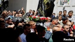 Mourners carry the body of Palestinian man Saleh Sabra, who was killed in an Israeli raid, in Askar Camp in Nablus, in the Israeli-occupied West Bank, May 15, 2023.