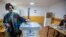 A woman casts her ballot at a polling station in the northern Serb-dominated part of ethnically divided town of Mitrovica, Kosovo, April 21, 2024. 