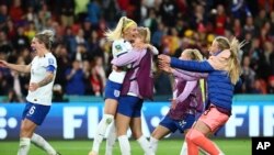 England's Chloe Kelly, center, celebrates after scoring the last goal during a penalty shootout at the Women's World Cup round of 16 soccer match against Nigeria in Brisbane, Australia, Aug. 7, 2023. 