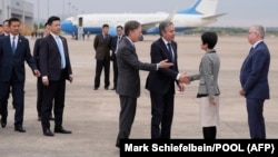 U.S. Secretary of State Antony Blinken, third from right, speaks to other officials as he prepares to depart Shanghai Hongqiao International Airport for Beijing, China, April 25, 2024.