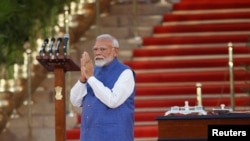 India's Prime Minister Narendra Modi gestures during a swearing-in ceremony at the presidential palace in New Delhi, June 9, 2024.