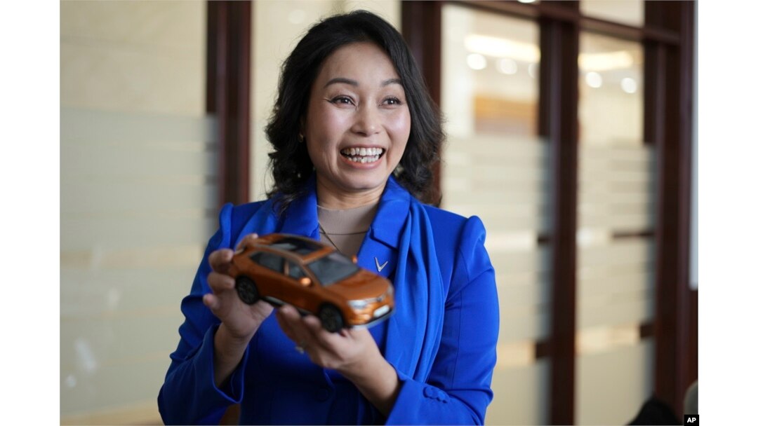 Vinfast CEO Le Thi Thu Thuy holds up a miniature model of a Vinfast car in Hanoi, Vietnam, on Sept. 29, 2023.